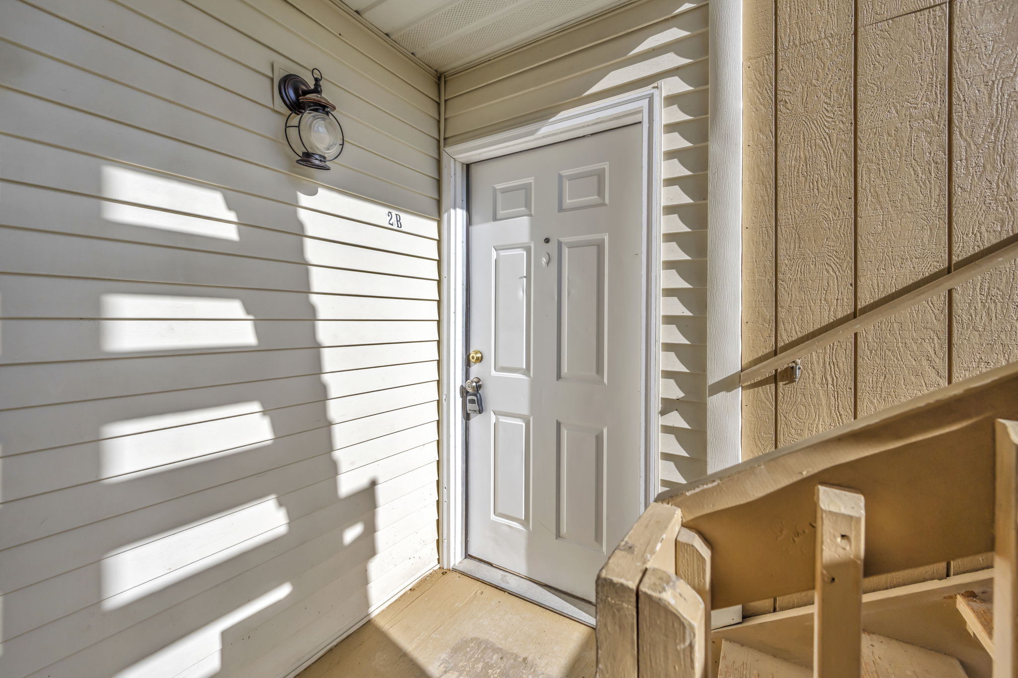 apartment front door with sunrays beaming