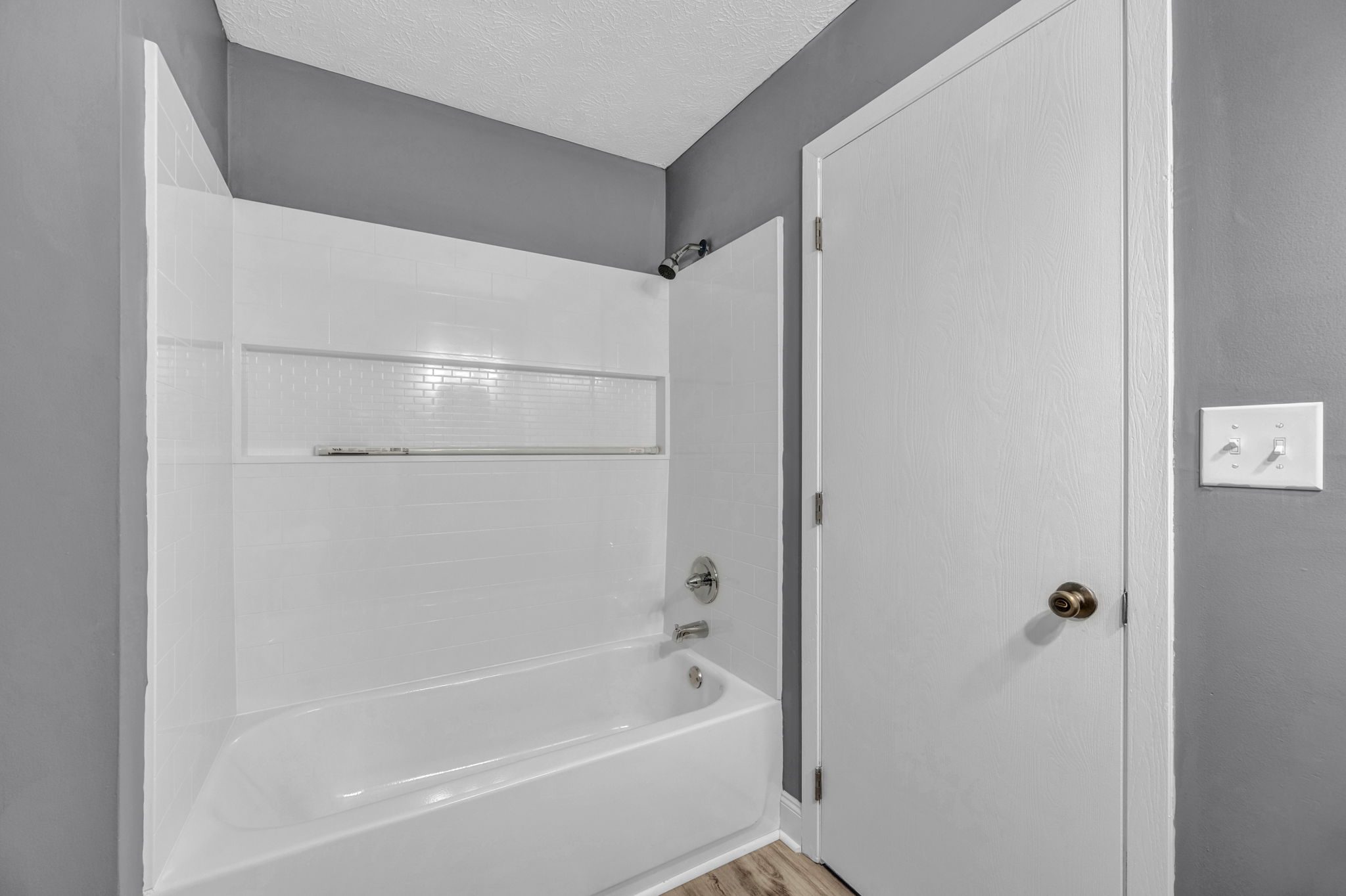 bathroom with white shower and white door