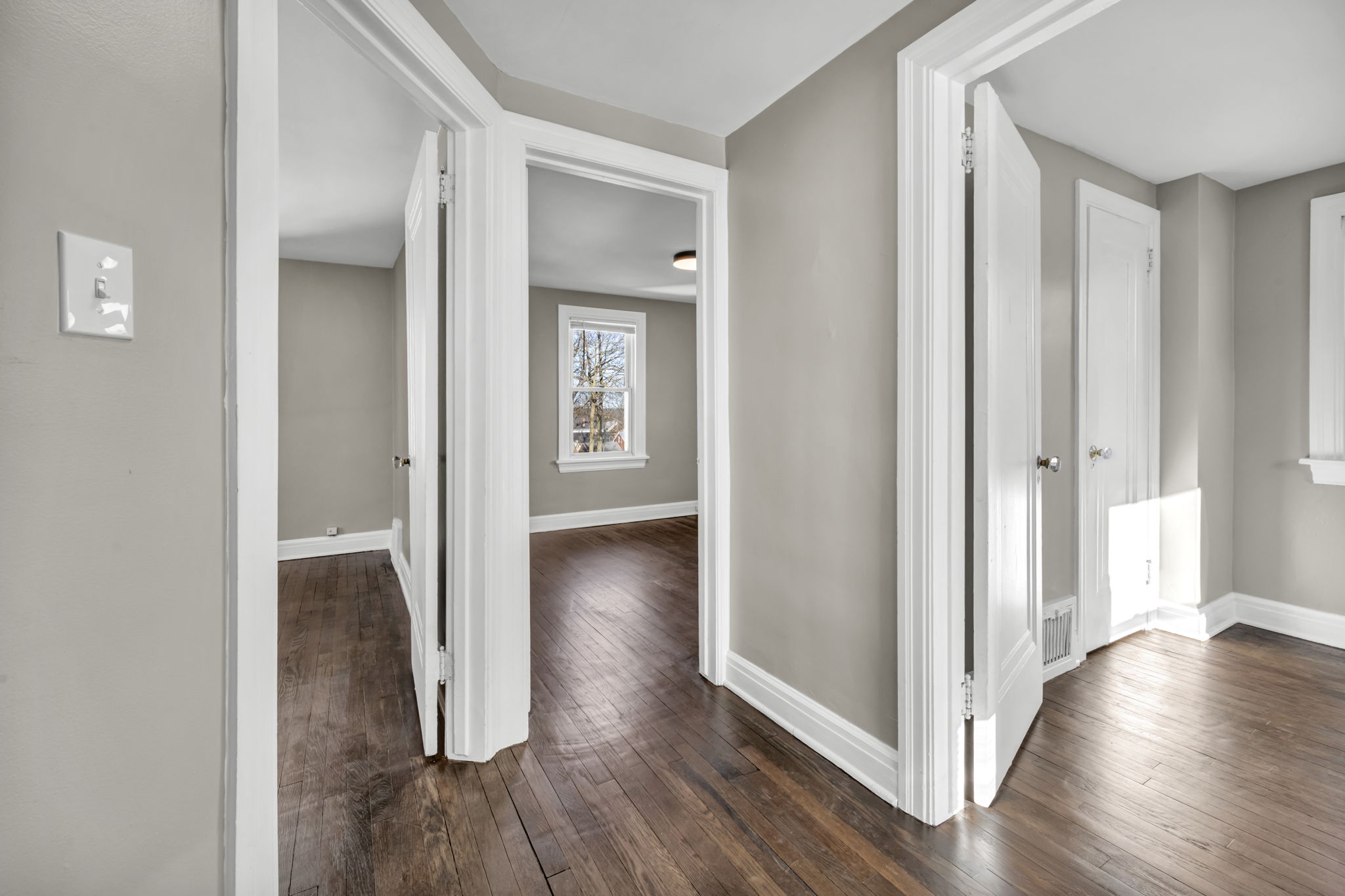 picture of hallway with doors open into rooms upstairs