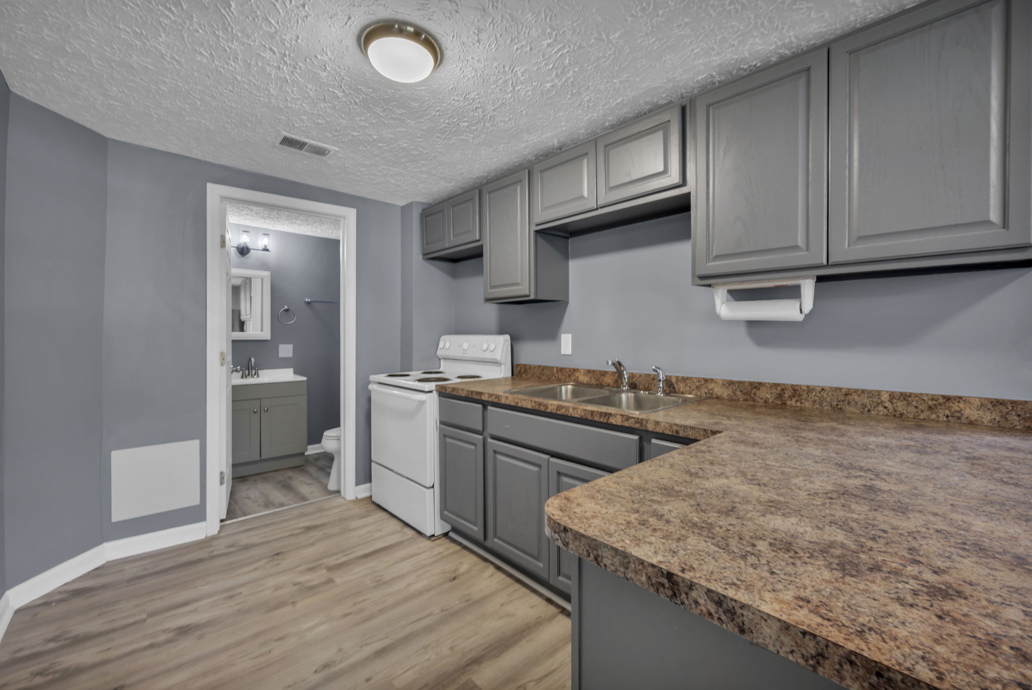 3rd kitchen photo with partial bathroom