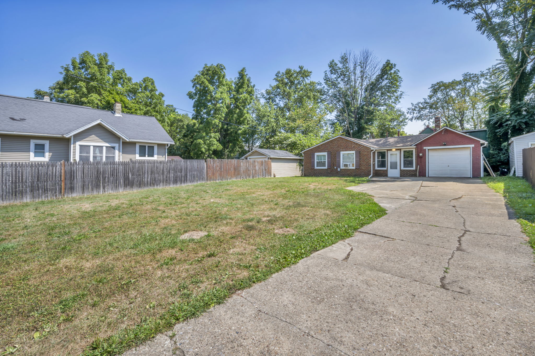 yard and driveway photo facing home