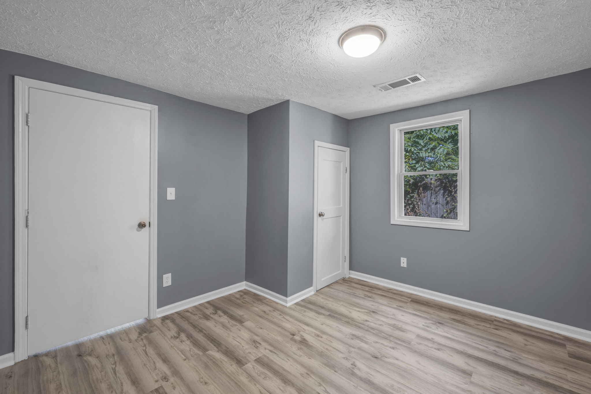 third photo of living room with window and closet