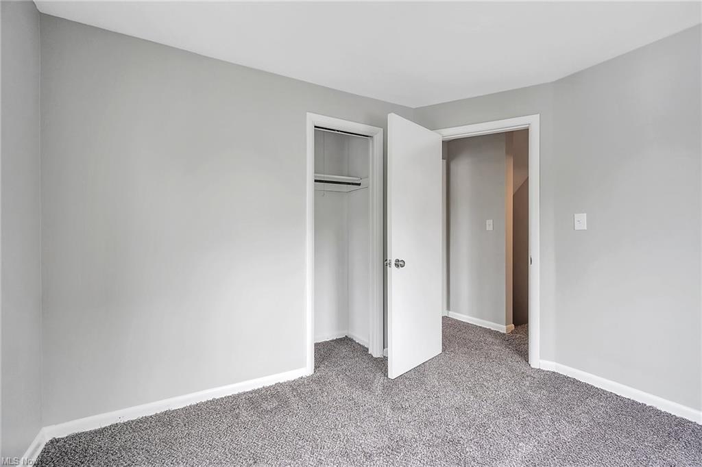 bedroom photo with closet open and exit door open
