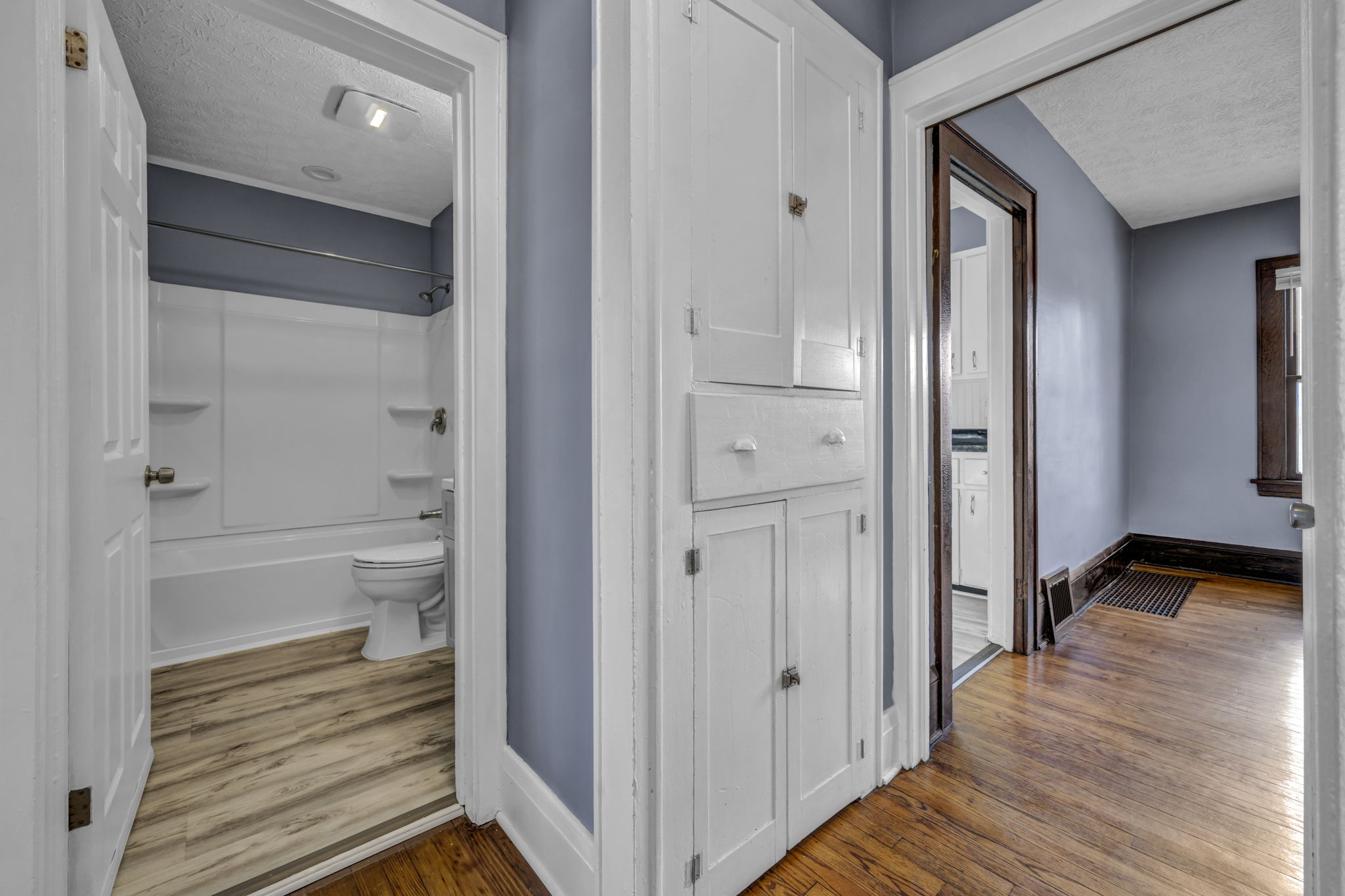 hallway with bathroom door open
