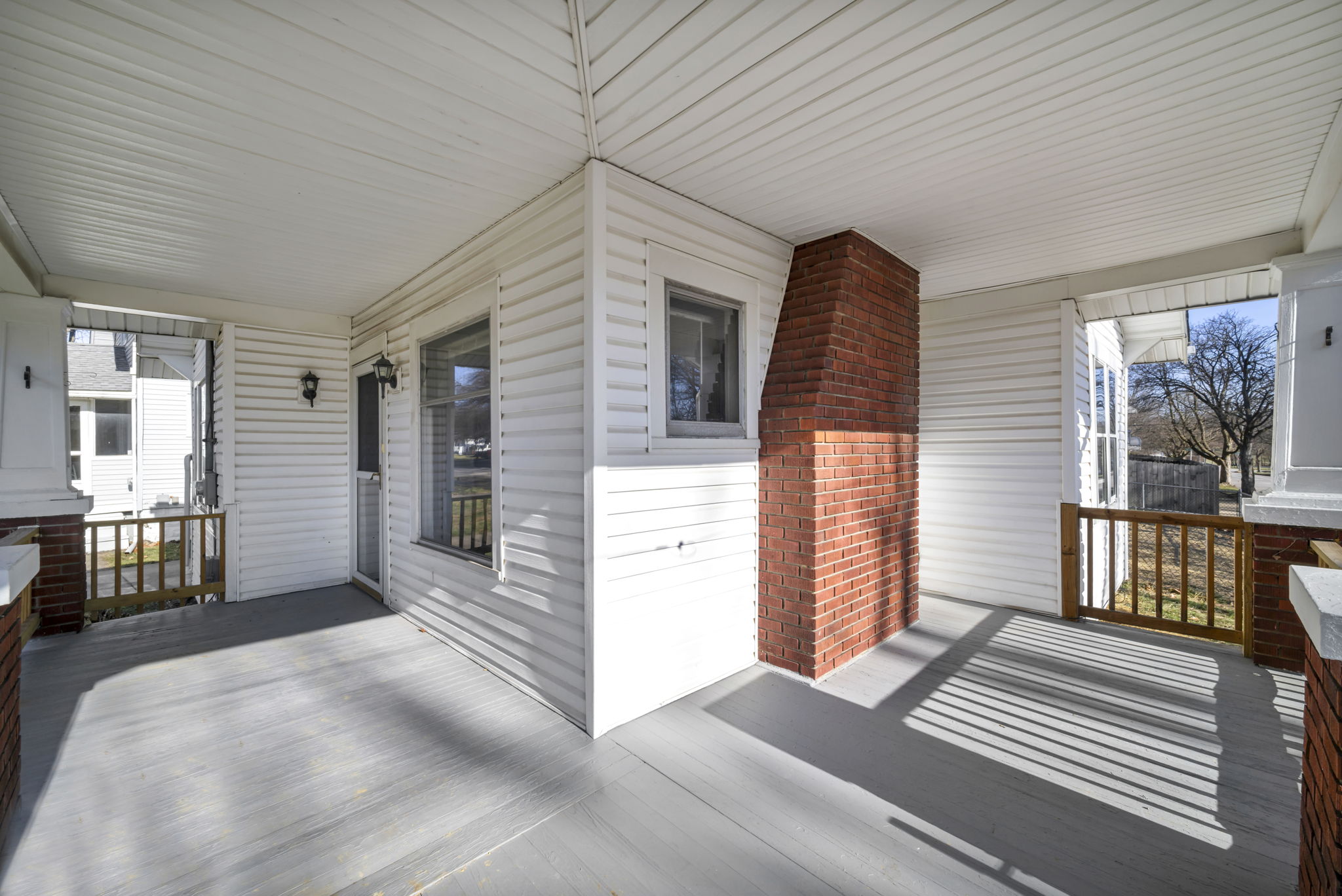 porch and house photo with brick and white vinyl