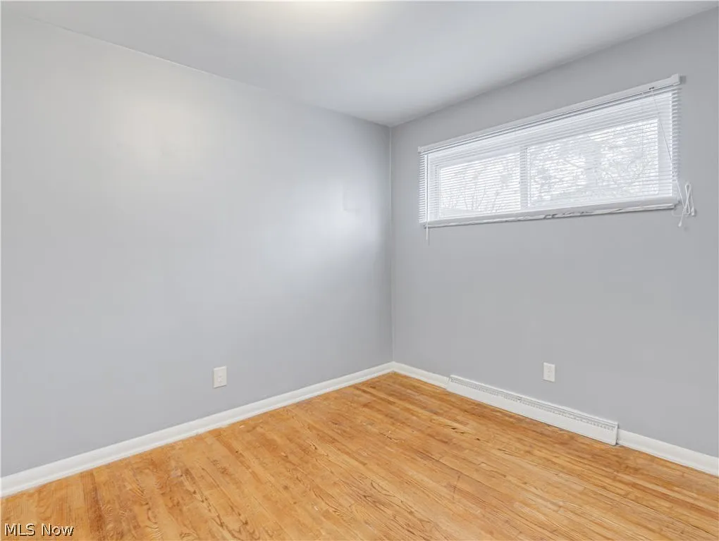 bedoom photo with hardwood and window