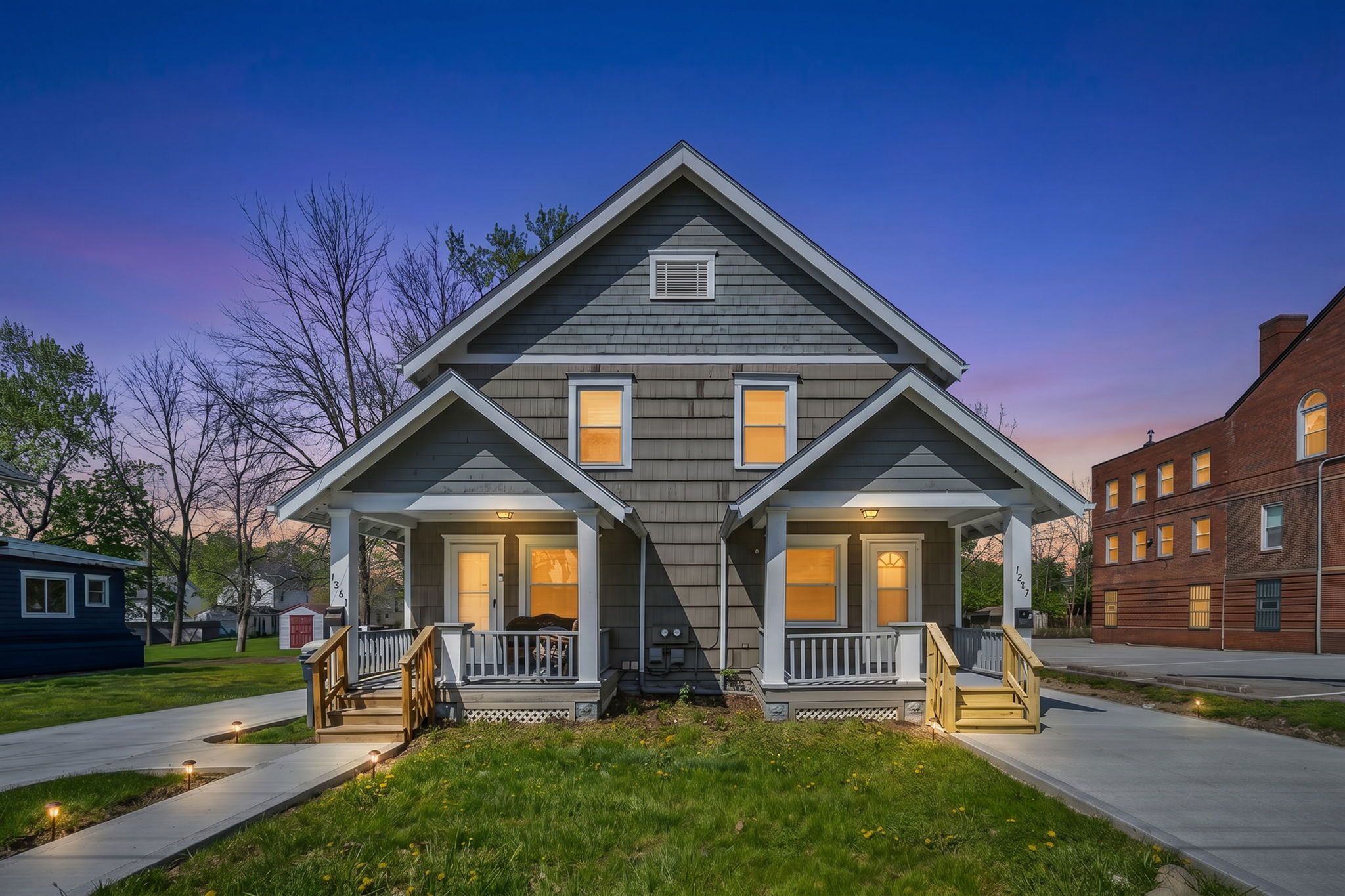 Kenmore duplex exterior with fresh new concrete at dusk