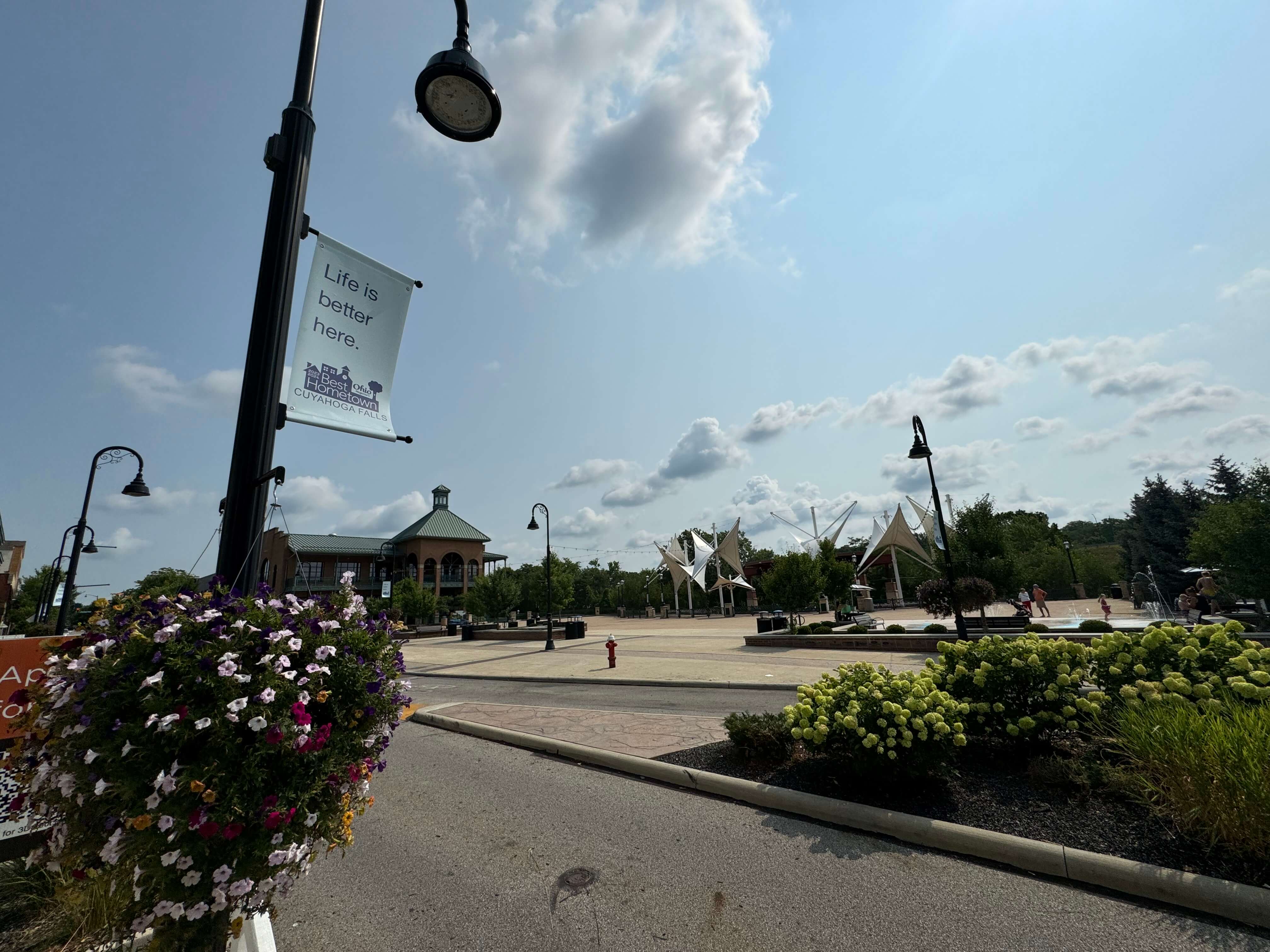 downtown cuyahoga falls with water works in the background and street light with sign