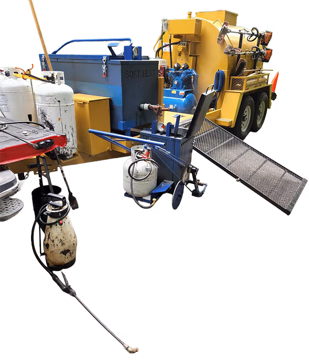 Professional asphalt maintenance equipment on-site in the Grand Traverse region, showcasing specialized hot rubber crack sealing for high-traffic commercial parking lot infrastructure.