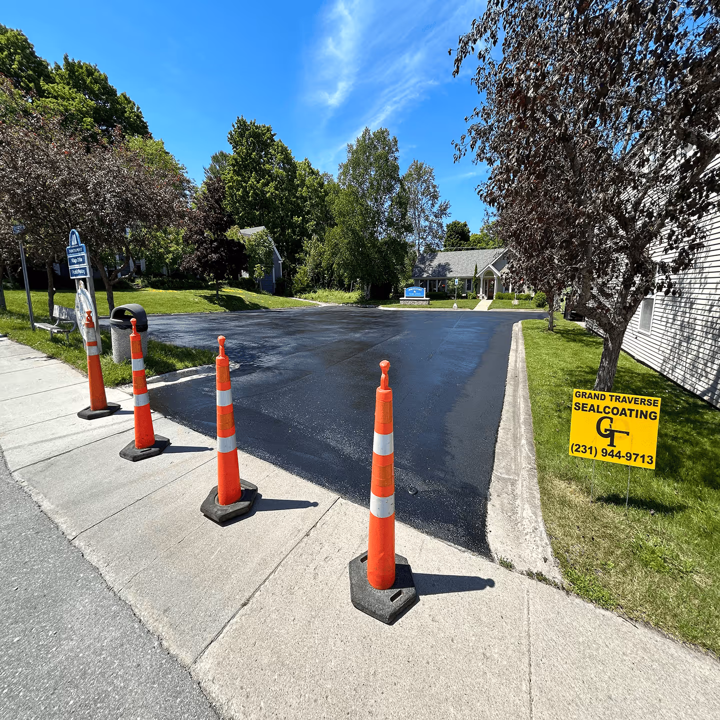 Professional commercial parking lot sealcoating for the Northport Village Office on W Nagonaba St in Northport, MI.