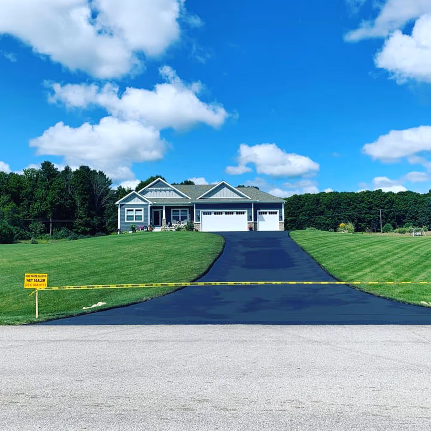 Professional residential driveway sealcoating for a waterfront home on Long Lake.