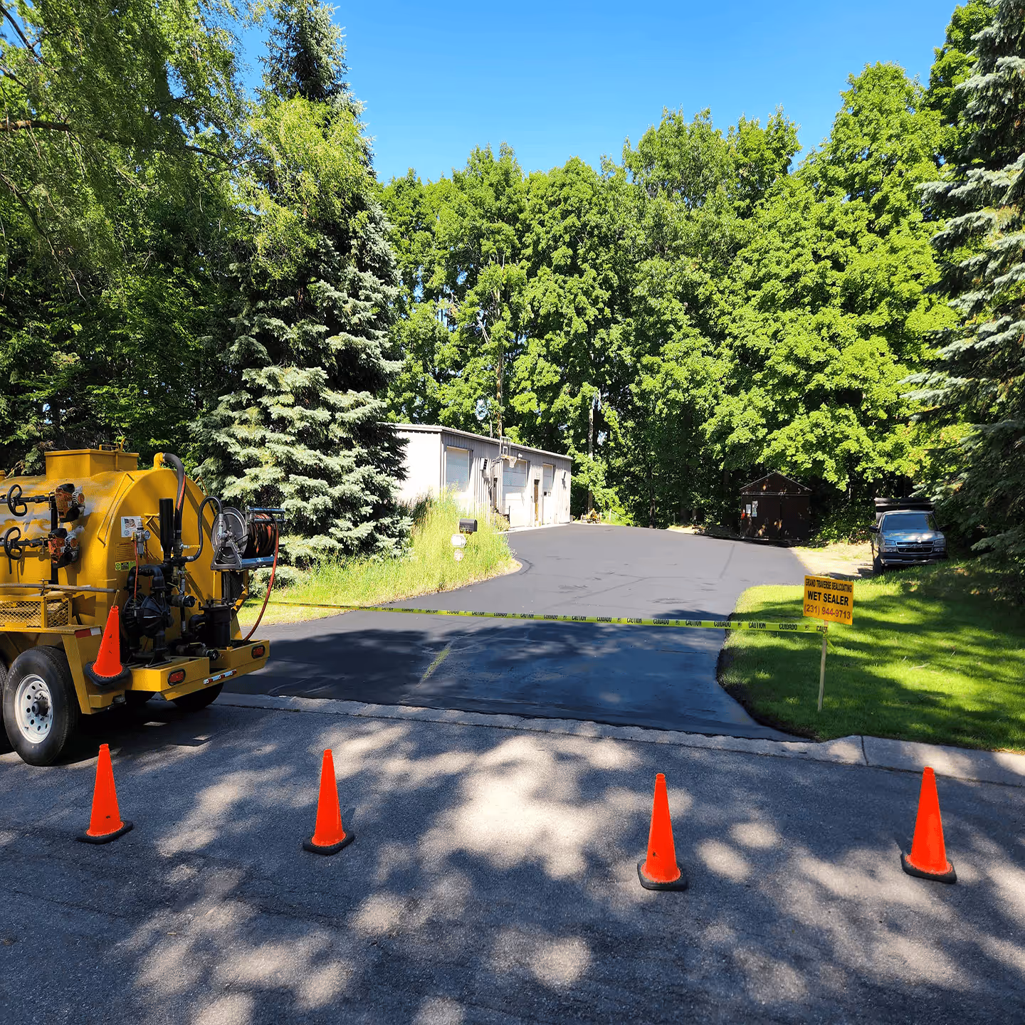 Commercial parking lot sealcoating for the Grand Traverse Country Club on S Union St in Traverse City, MI.