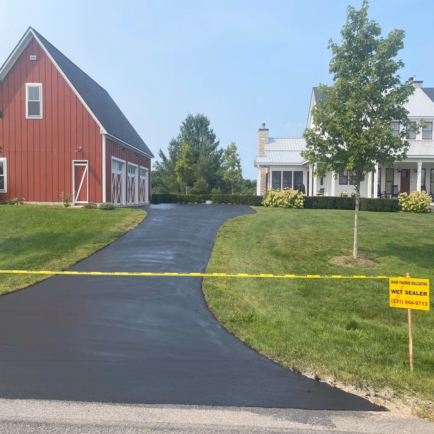 High-quality asphalt sealcoating applied to a private driveway on Old Mission Peninsula.