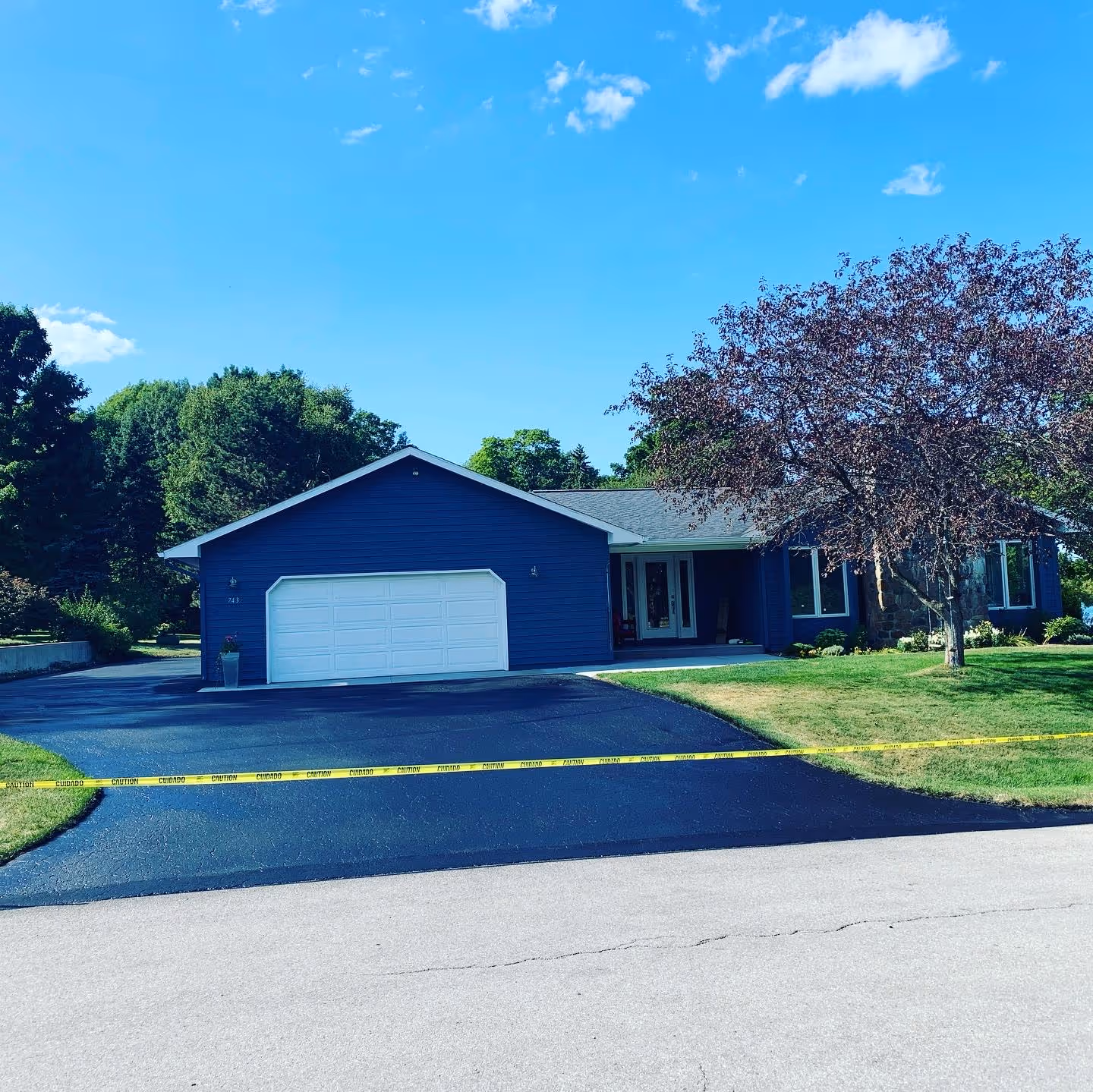 Newly applied asphalt sealcoat for a driveway in a quiet Traverse City residential subdivision.