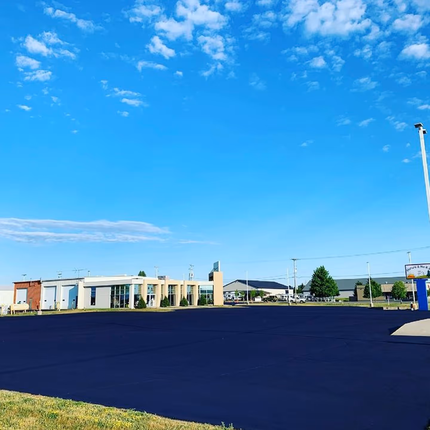 Commercial parking lot sealcoating for Nature & Me RV at the intersection of Rennie School Rd and U.S.-31 S in Traverse City, MI.