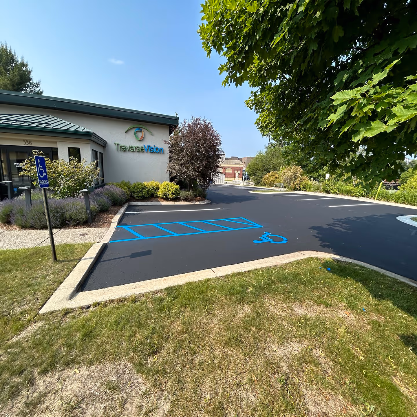 Professional commercial parking lot sealcoating for Traverse Vision on W Front St in Traverse City, MI.