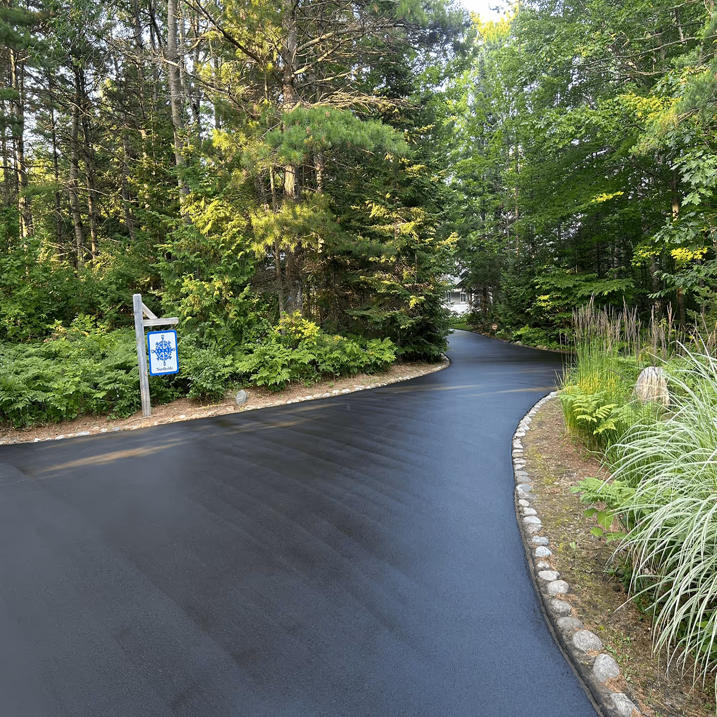 Professional residential driveway sealcoating for a home in the village of Northport.