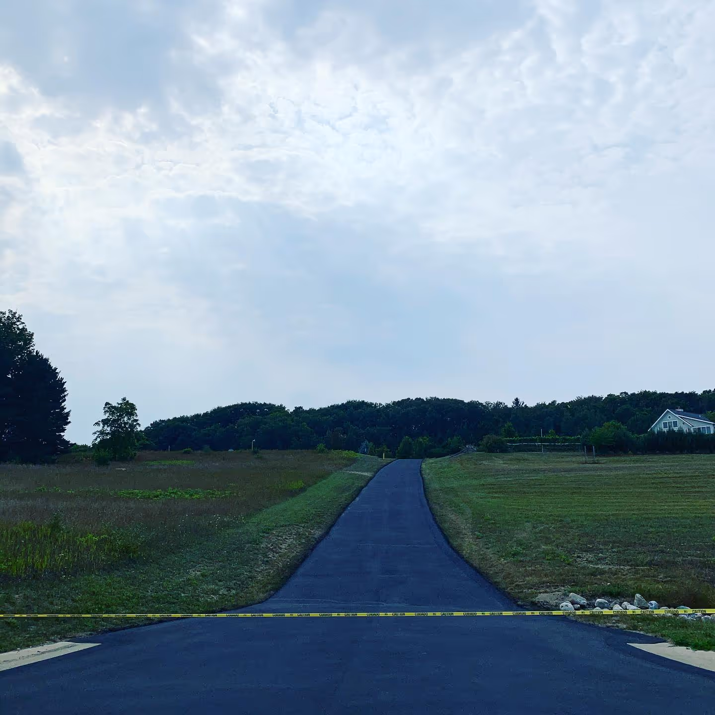 Precision hand-brushed sealcoating for a residential driveway in Northport, Michigan.
