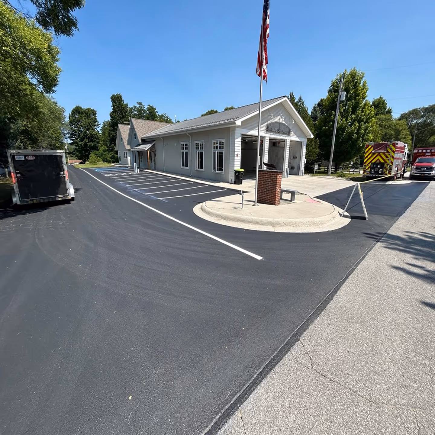 Durable commercial parking lot sealcoating for the Lake Leelanau Fire Station on W Main St in Lake Leelanau, MI.