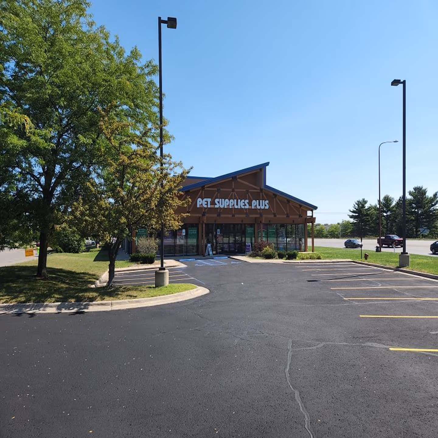Professional commercial parking lot sealcoating for Pet Supplies Plus on West South Airport Rd in Traverse City, MI.