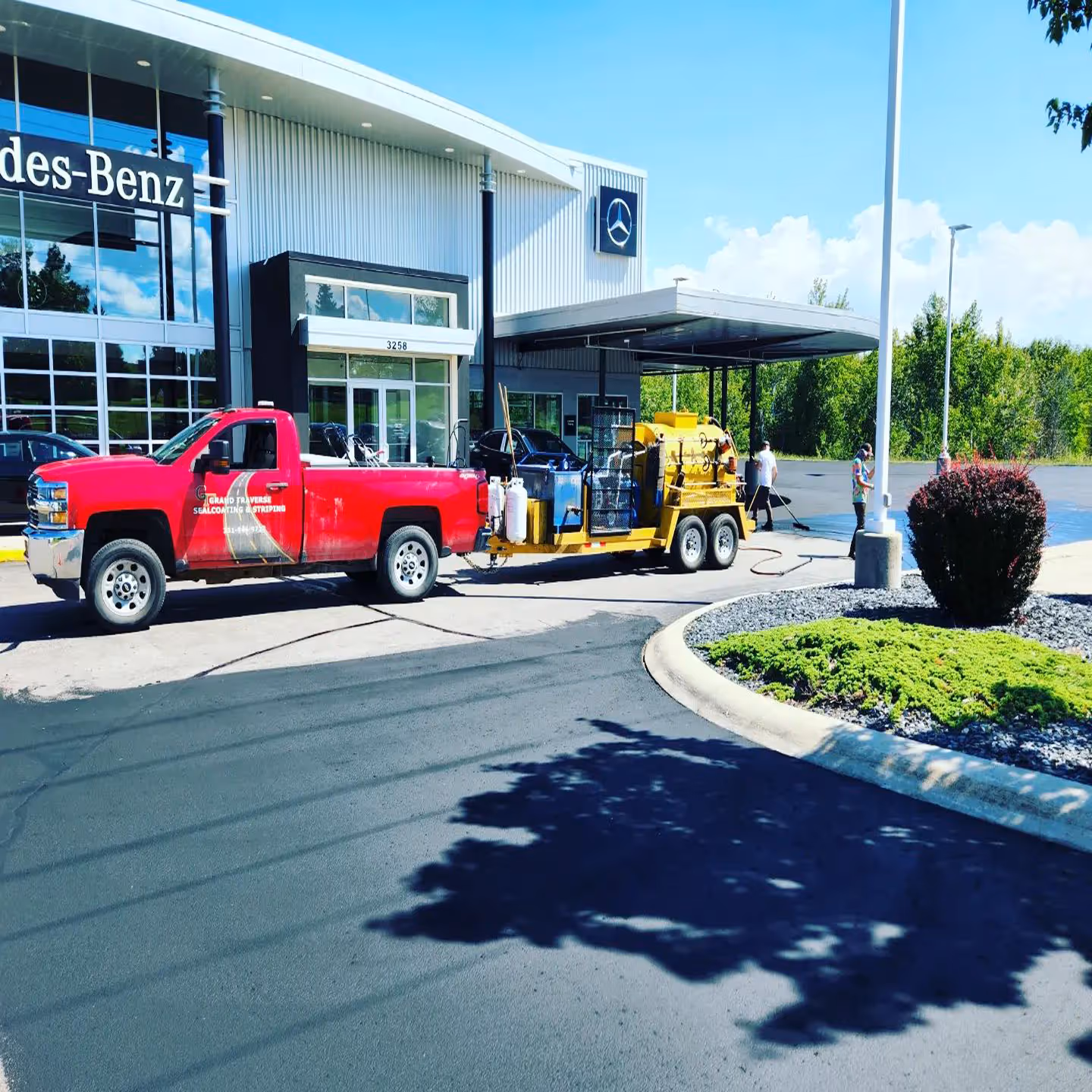Premium commercial parking lot sealcoating for Mercedes-Benz of Traverse City on N U.S. 31 S, featuring a clean, professional jet-black asphalt finish.