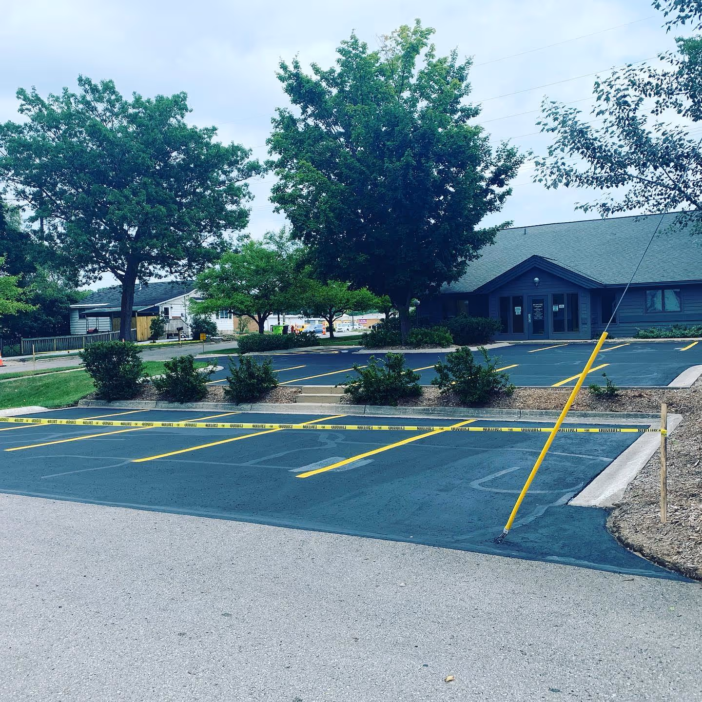 Professional commercial parking lot sealcoating for Soave Eye Care on S Garfield Ave in Traverse City, MI.