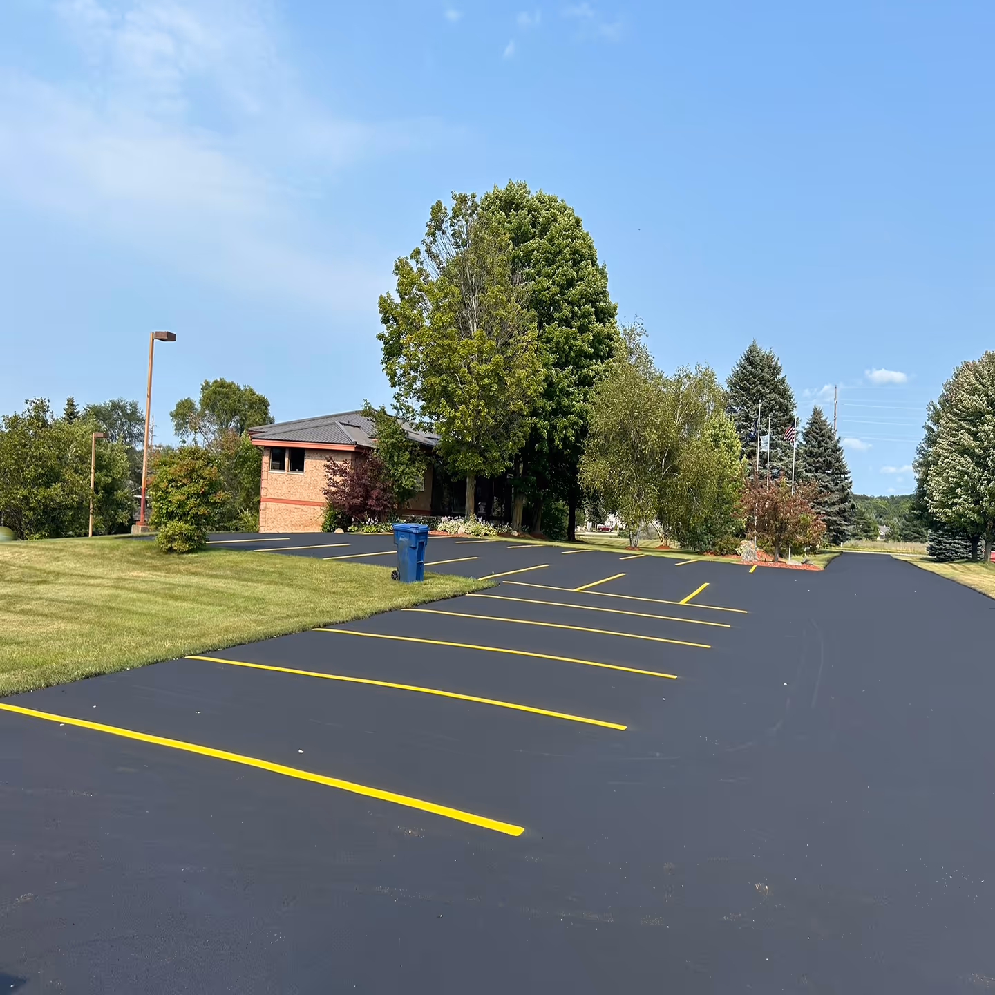 Freshly sealed commercial asphalt parking lot for Advanced Financial Group on N Four Mile Rd in Traverse City, MI.