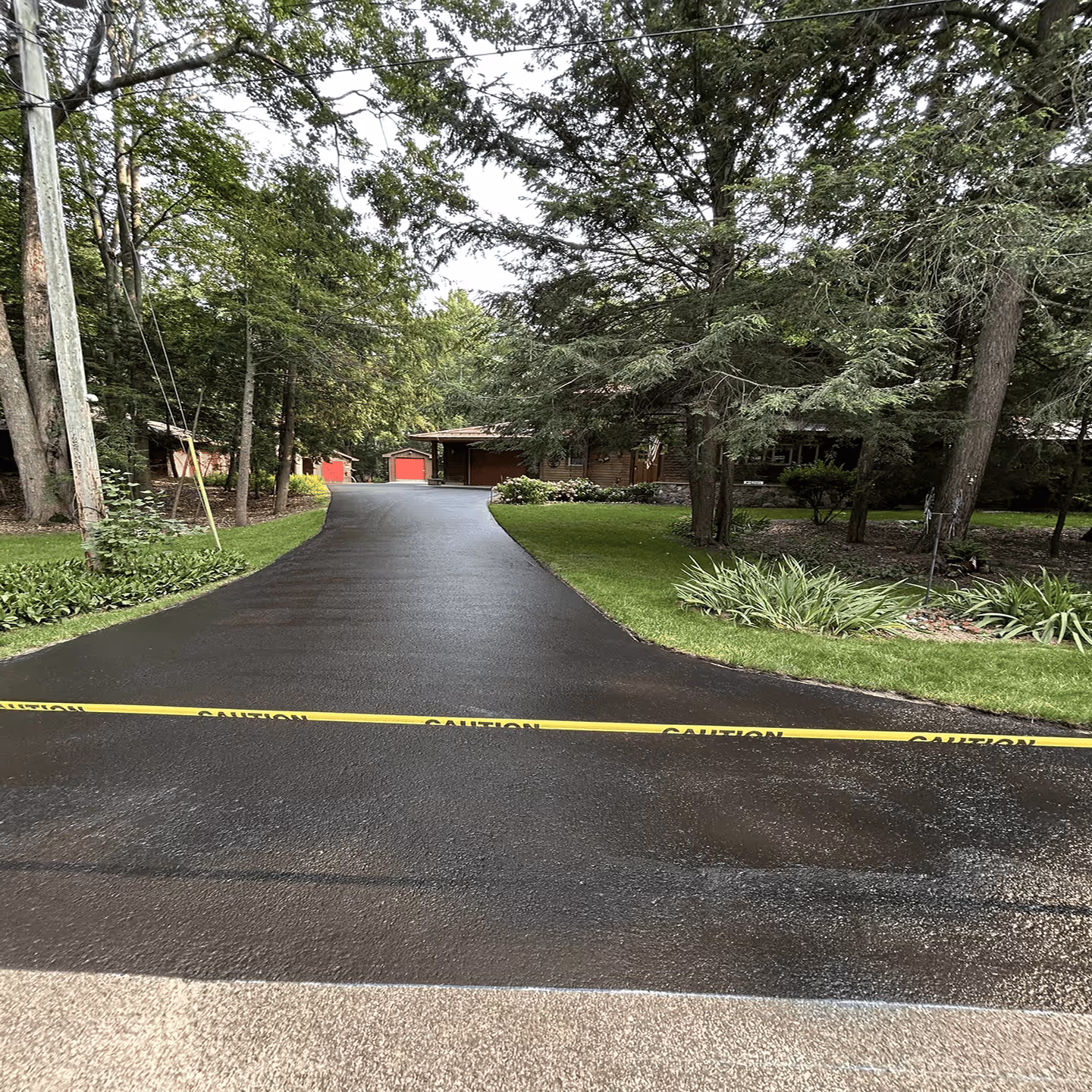 Boosting residential curb appeal with a professional sealcoat finish for a home in Leland.