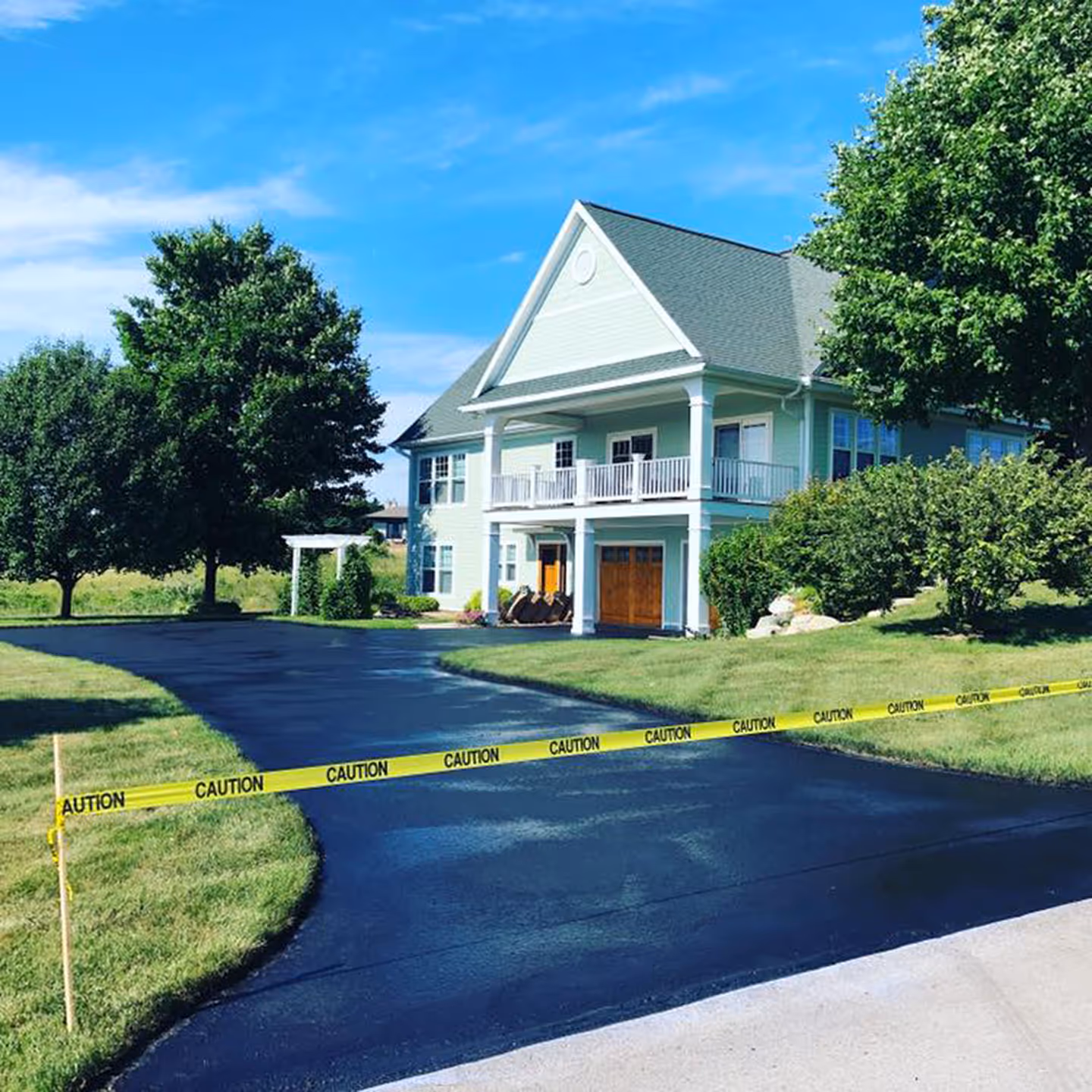 Comprehensive asphalt crack filling and sealcoating for an Old Mission Peninsula residence.