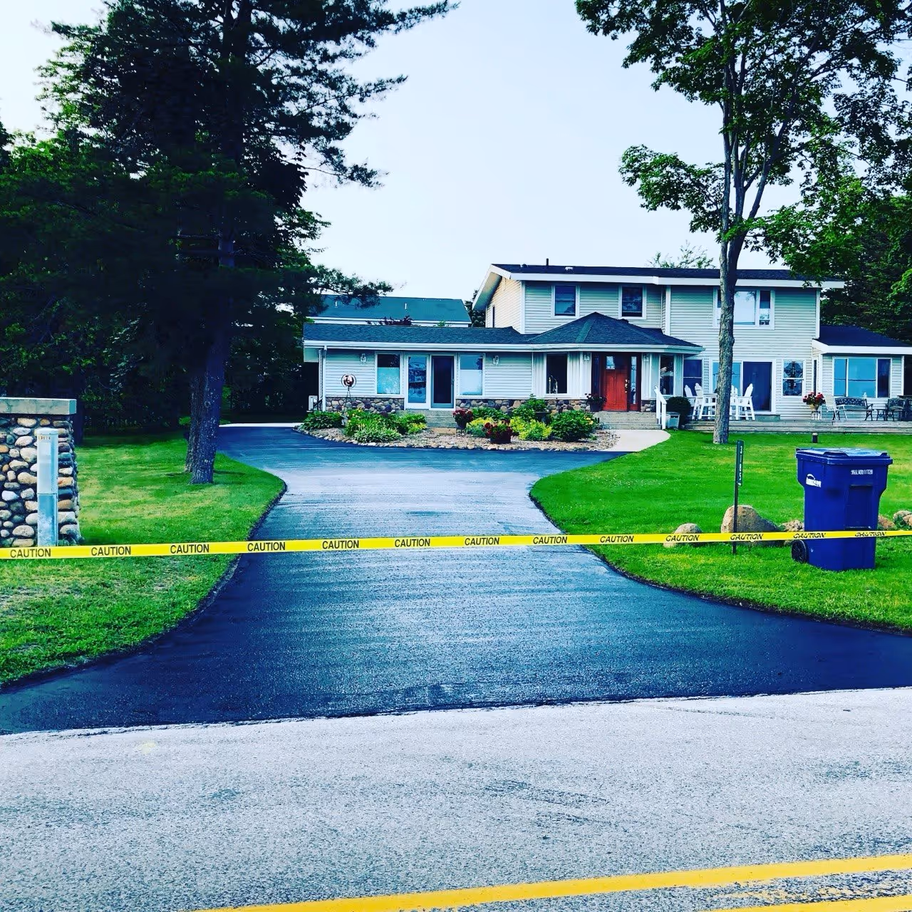 Professional asphalt sealcoating and protection for a residential driveway in Maple City.