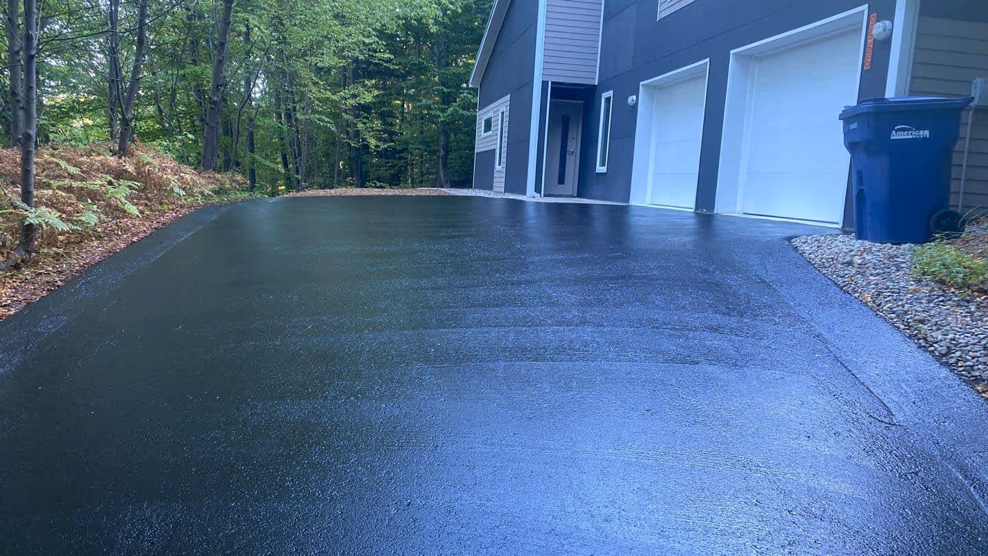 Boosting residential curb appeal with a professional sealcoat finish for a home near Long Lake.
