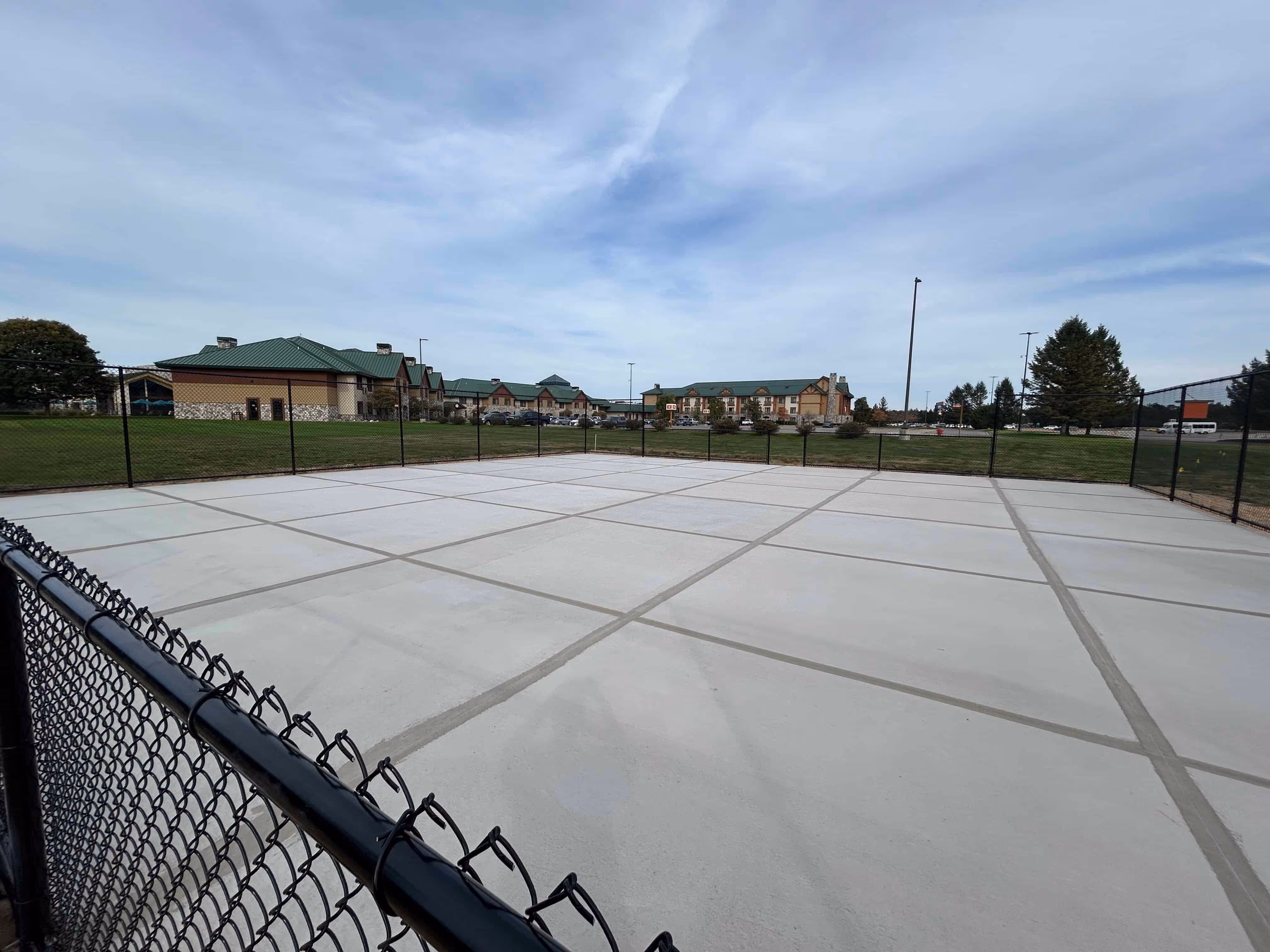Professional cleaning and surface preparation of brand-new asphalt at Little River Casino Resort Hotel in Manistee, MI, before the surfacing process begins.
