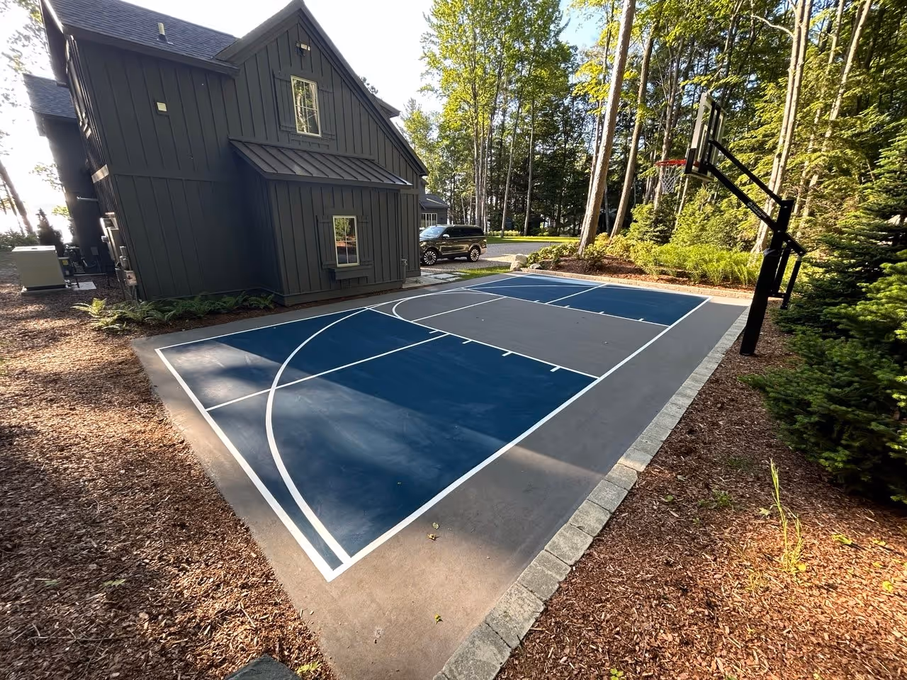 The completed, premium-surfaced multi-sport combination court in Alden, MI, featuring a two-tone finish and dual-sport striping for basketball and pickleball.