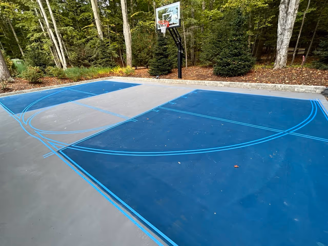 Meticulous layout and precision hand-taping for overlapping basketball and pickleball lines on a custom combination court surface.