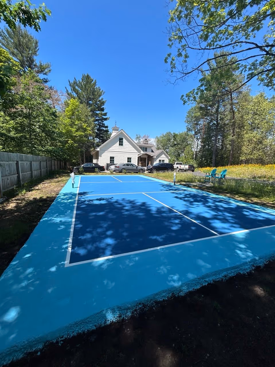 The completed, professionally resurfaced pickleball court on Torch Lake, featuring a high-performance finish and precision line striping.