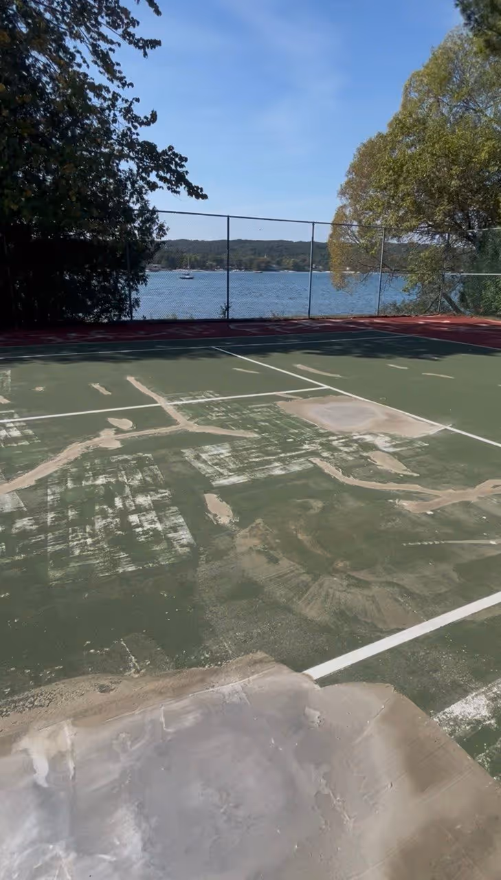 High-performance asphalt crack filling and low spot leveling on the private Suttons Bay court to ensure a perfectly flat and safe playing foundation.