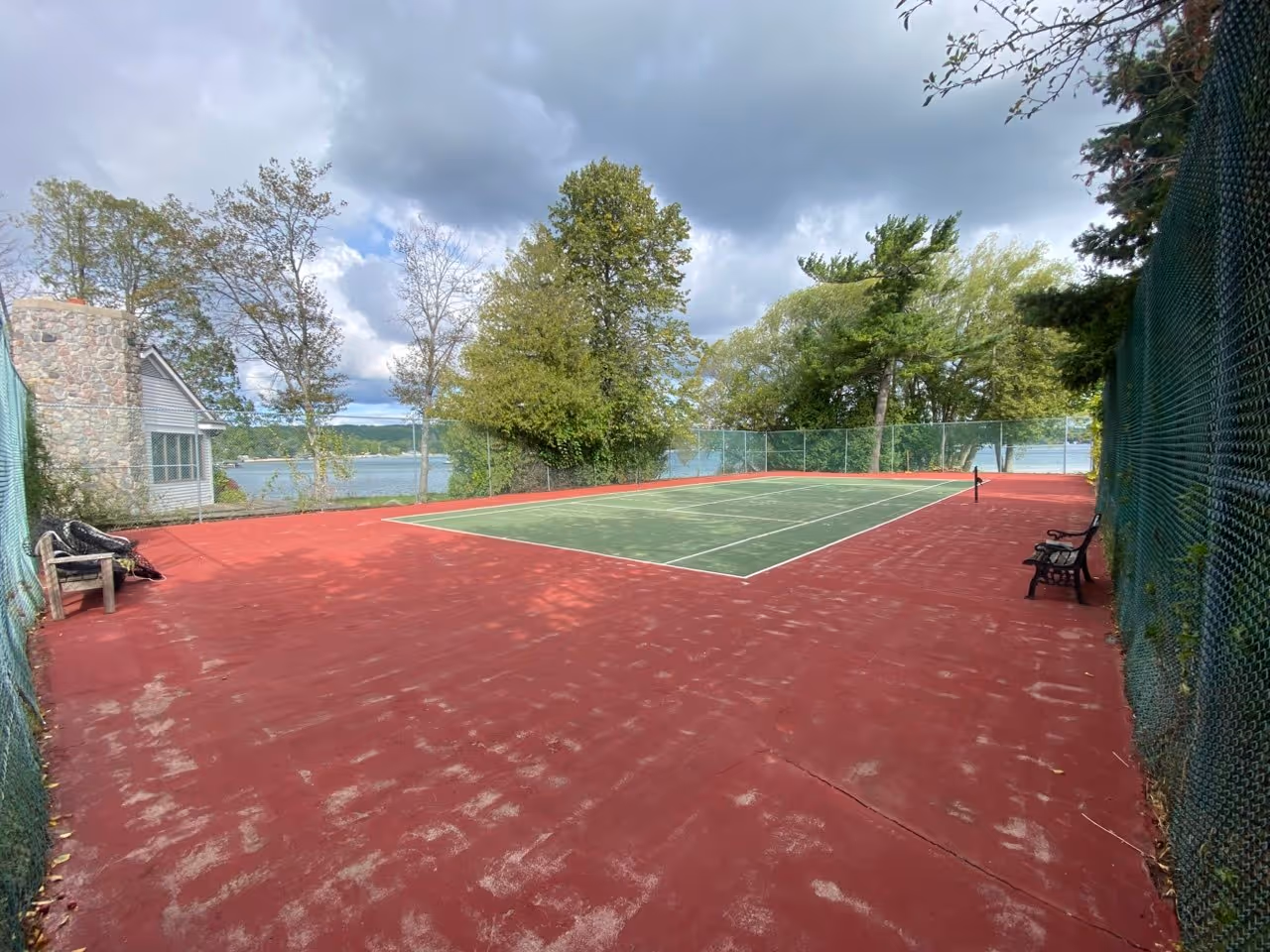 The entire tennis court surface pressure washed and cleared of all weeds, prepared and ready for professional crack filling and leveling.