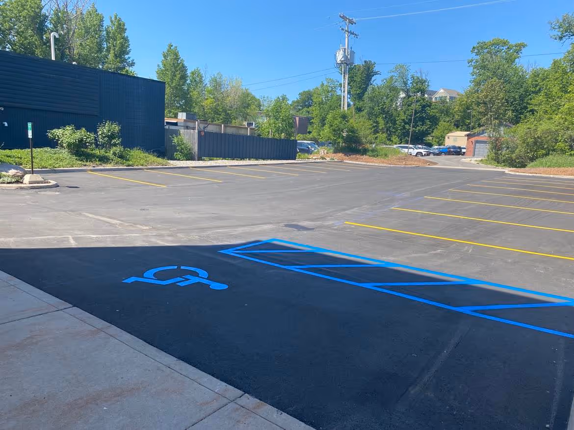A new commercial parking lot layout and high-visibility yellow striping for Fitzmaurice-Gavin Insurance on SW Bayshore Dr in Traverse City, MI. This project, completed for Team Elmer's, features precision pavement markings on the scenic West Bay/M-22 corridor, enhancing safety and curb appeal for the professional office.