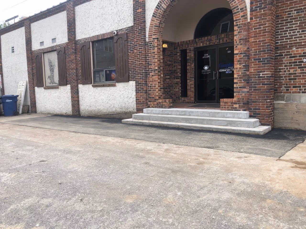 The completed entrance repair at Rare Bird Brewpub in Traverse City, MI. All cones are removed and the new asphalt is fully open to traffic, providing a safe and clean entry point for the local brewery.