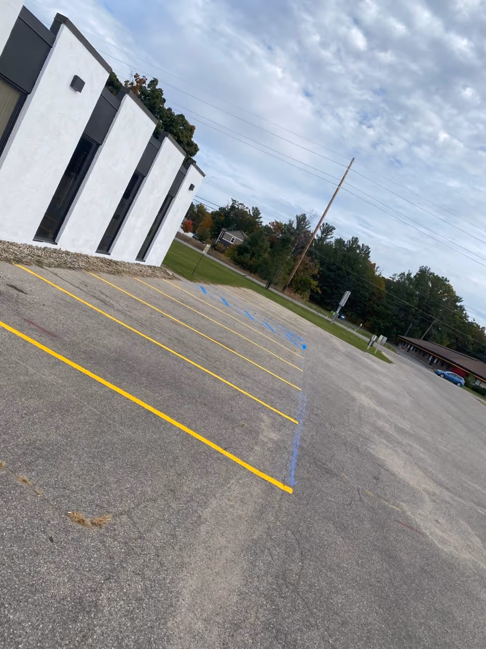 Professional commercial parking lot striping and high-visibility stall layout at Cintas Facility and Uniform Services on Barlow Street in Traverse City, Michigan.