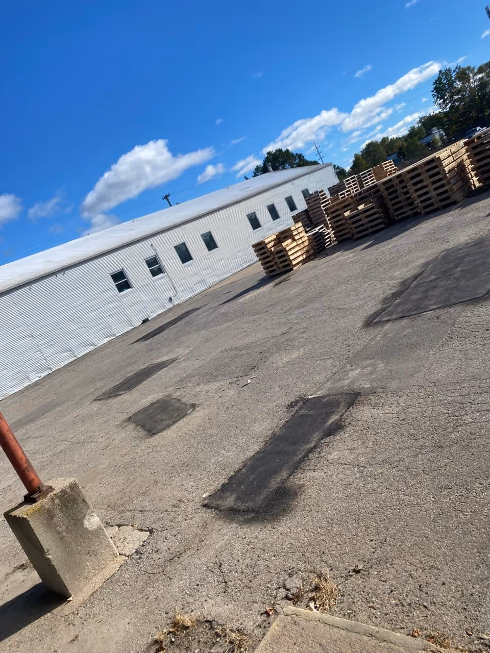 Professional infrared asphalt repair on a commercial loading dock at the Cone Drive facility on E Twelfth Street in Traverse City, Michigan