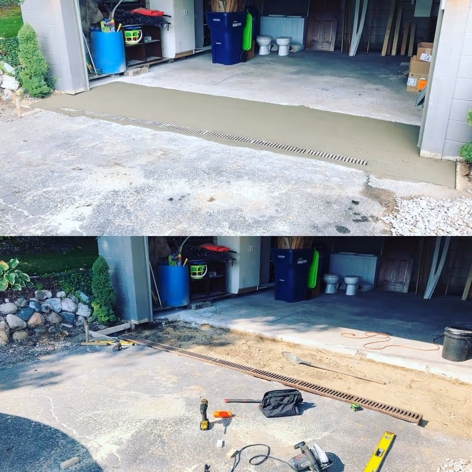 Before and after of a French drain installation between an asphalt driveway and concrete garage apron at Silver Lake in Traverse City, MI, showing the structural concrete removal, gravel base prep, and the final finished concrete pour.