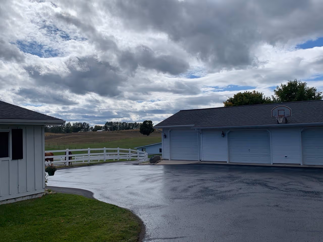 A sprawling asphalt driveway and expansive parking area for a private horse ranch off Lautner Rd in Solon Township, located near Traverse City, MI. This paving project was completed for attorney Douglas Fierberg and The Fierberg National Law Group.