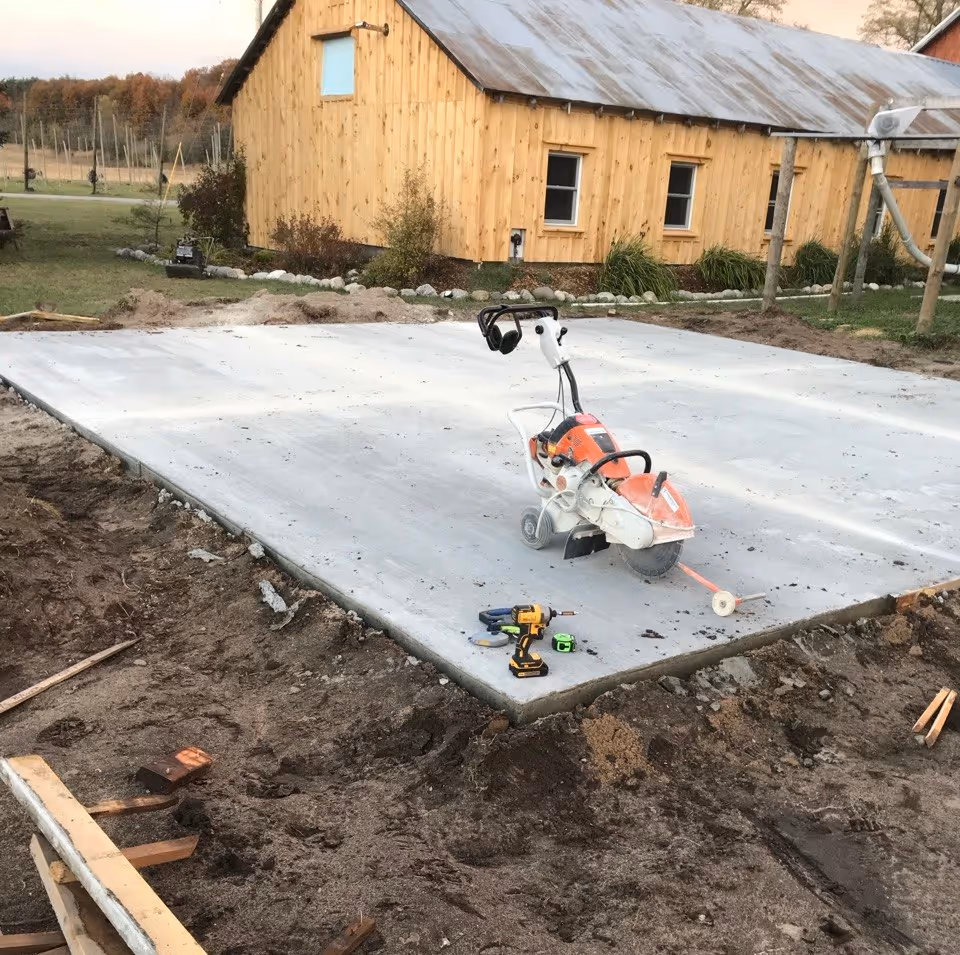 A Stihl TS800 concrete saw on a cart being used to cut relief joints in a new shed slab outside Empire, MI. A DeWalt impact was used for efficient form removal.