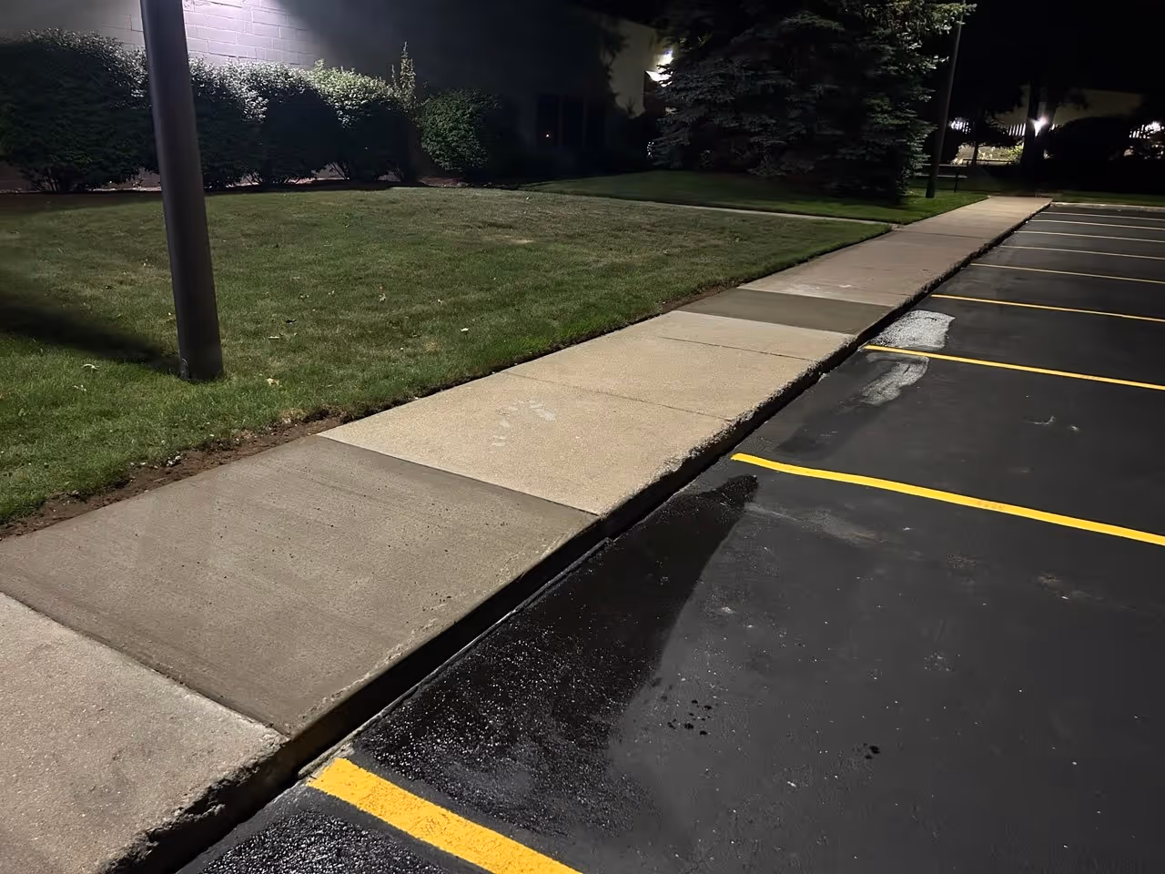 The final completed concrete sidewalk with form boards removed and site restored at VP Demand Creations in Traverse City.