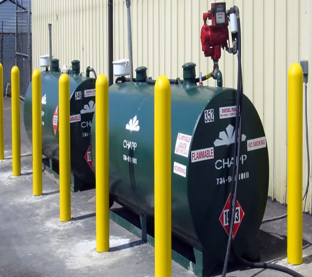 New concrete bollards installed around commercial fuel tanks to provide impact protection for a local transportation company in Traverse City.