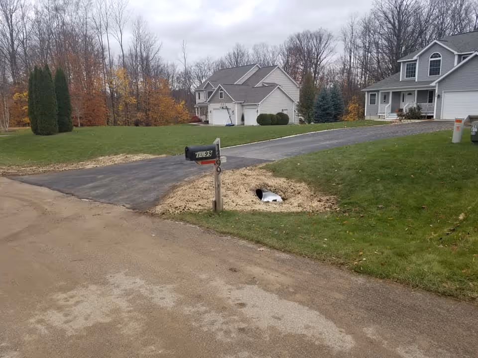 A secondary angle of the finished culvert project in South Creek Subdivision, showcasing the clean asphalt joints and professional-grade finish.