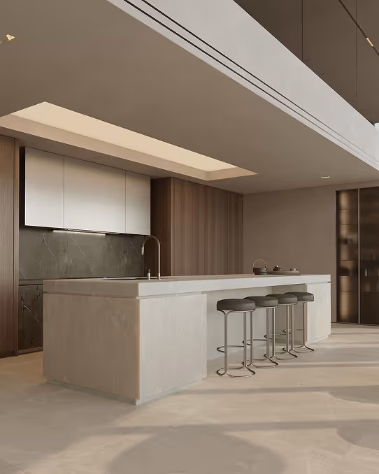Modern kitchen with a large white island, four stools, overhead recessed lighting, and wood panel walls.