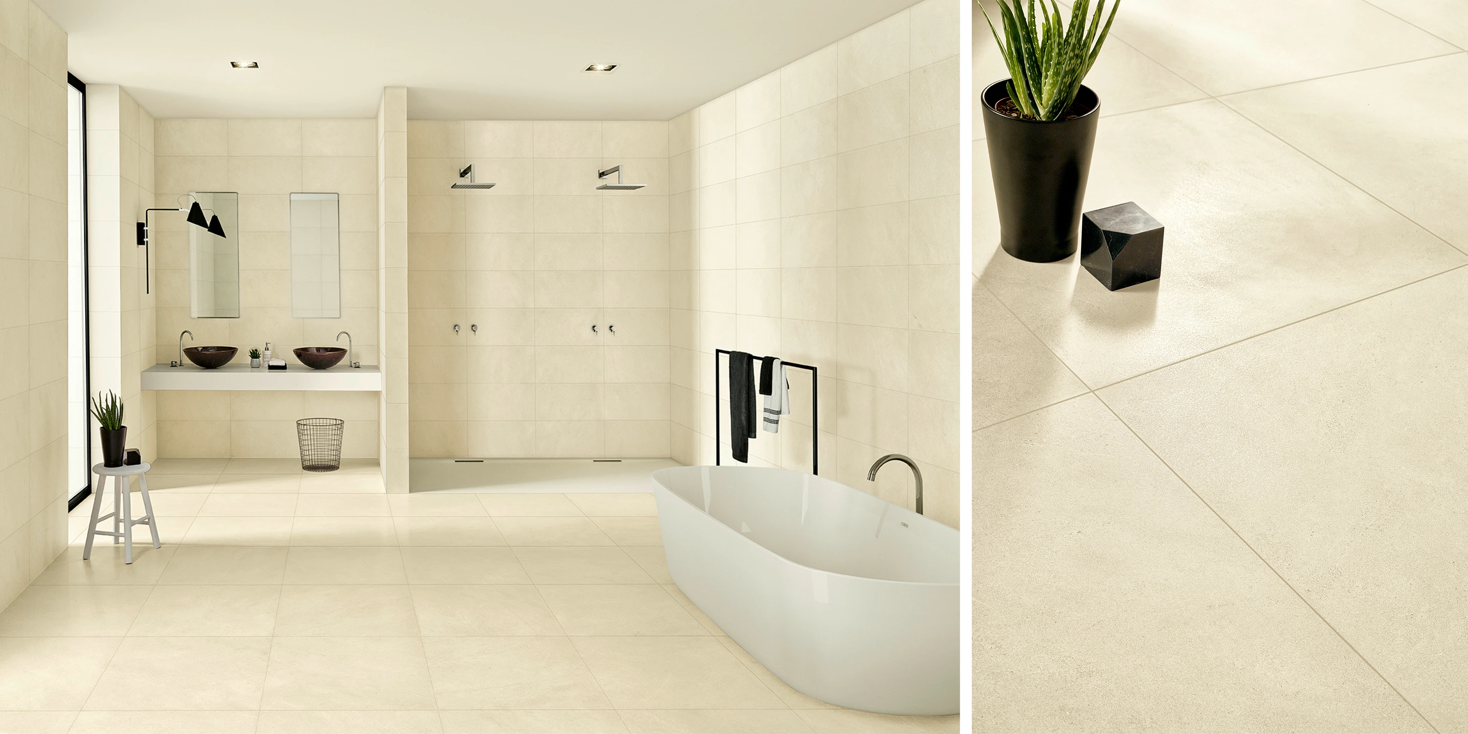 Modern bathroom with beige tiles, freestanding tub, double sinks, two showers, and black towel rack.