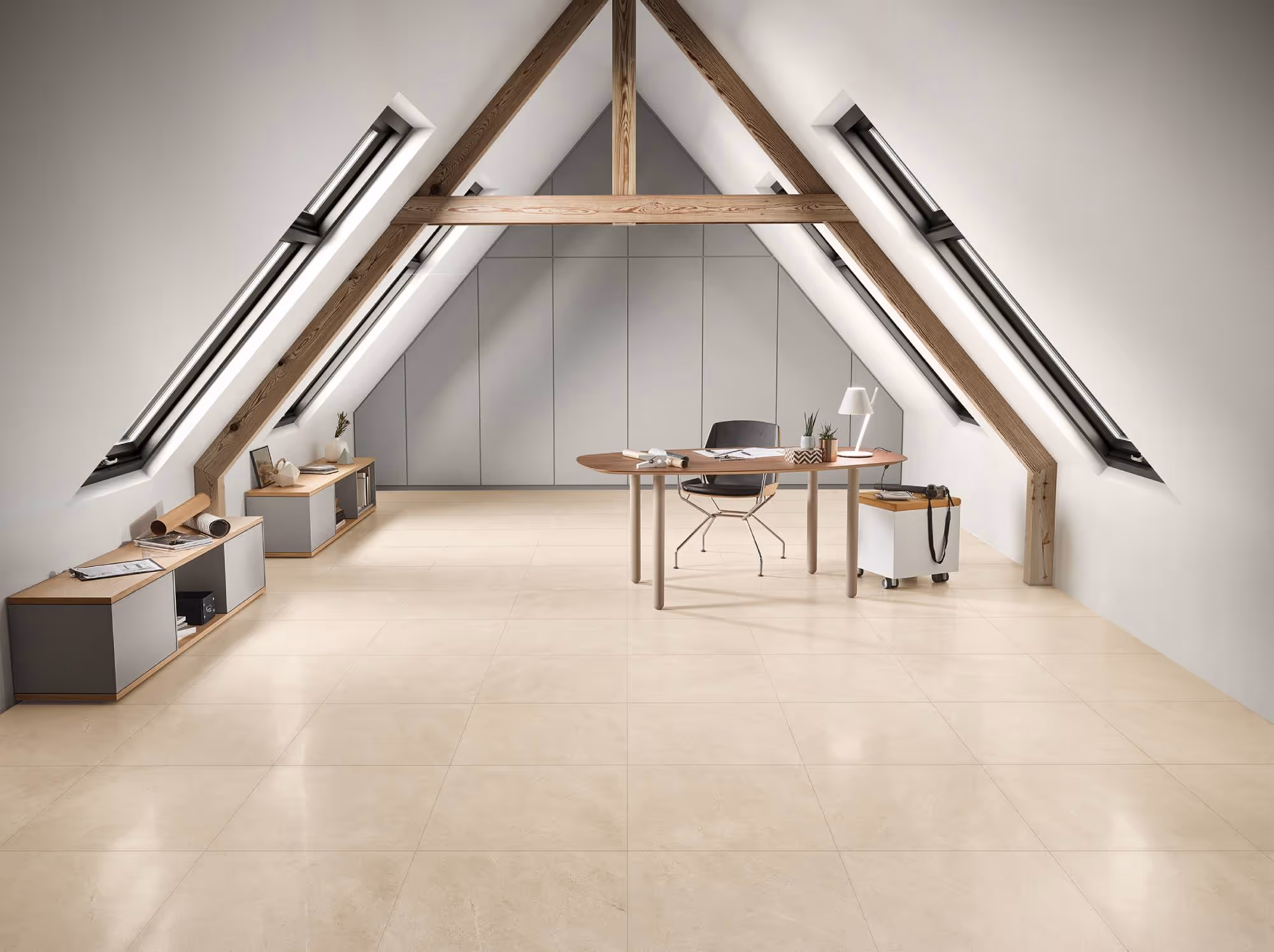 Minimalist office under angled roof with wooden beams, skylights, beige tiled floor, and modern desk.
